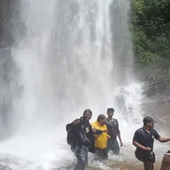 Trekkers having a great time in the powerful currents at the base of Hidlumane Falls during our Kodachadri trek.