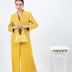 This butter yellow bag is perfect for the summer season. I designed it with a unique triangular shape, a comfortable ruched handle, and an all-over polka dot pattern made from tiny glass stones.