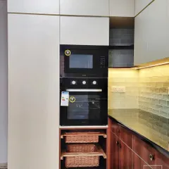 A look at the detailing in our kitchen units. This tall unit is designed to house a built-in oven and microwave, and includes custom pull-out wicker baskets for vegetable storage.
