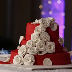 A detailed shot of a beautiful multi-tiered red wedding cake. I make sure to capture all the elements of your celebration, including the stunning culinary creations.