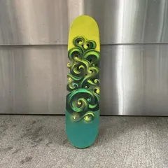 The finished 'Masala Style' skateboard deck, standing on its own. The carved letters create real depth and shadow, making it a true 3D piece.