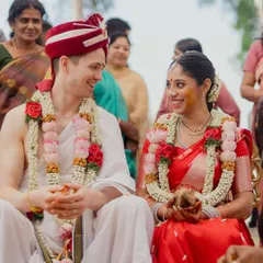 The joy is universal. This candid shot from a South Indian ceremony shows a beautiful moment of connection and happiness between a multicultural couple.