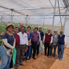 A happy group of visitors and senior citizens enjoying a day at our farm. We host wellness outings for elders, filled with harvesting, story-sharing, and simple, healthy food.
