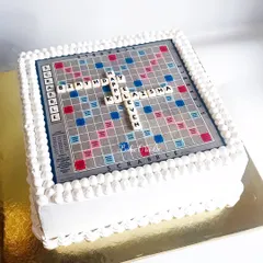 A Scrabble board cake for a board game lover's birthday. This 3kg Blueberry-Lemon cake features an edible print of the board and personalized letter tiles.