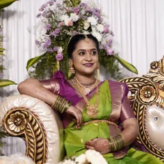 A beautiful mom-to-be at her baby shower. The makeup is kept elegant and glowing, and she looks radiant in her traditional green and purple silk saree.