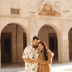 A quiet, tender embrace within the beautiful archways of a traditional Arabian souk. The soft light and historic setting create a deeply romantic and intimate portrait.