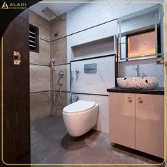 A stylish bathroom with a terrazzo-style vessel sink and a combination of marble and textured tiles. The design is clean, modern, and highly functional.