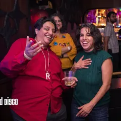 A candid moment from a Bollywood Disco party. These events are more than just a DJ set; they are interactive celebrations where people can connect with the music and each other in a joyful, chosen-family atmosphere.