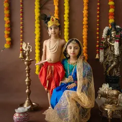 A lovely portrait of siblings dressed as Radha and Krishna for a Janmashtami photoshoot. This is a wonderful way to celebrate the festival and create lasting memories.