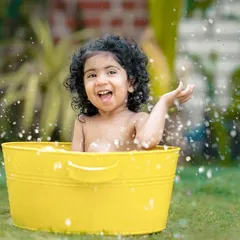 A big, joyful splash from a happy baby girl. We love capturing these moments of pure, uninhibited fun in our garden.