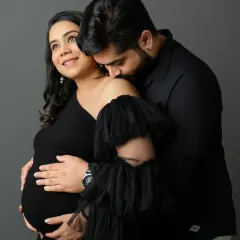 Dressed in elegant black, this intimate portrait focuses on the quiet bond and protective love between partners during this special time.