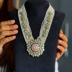 The beauty of a heritage piece lies in its details. This traditional polki necklace, with its intricate floral medallion and strings of pearls, is a perfect example of timeless design. It’s crafted to be an evergreen treasure for a bridal trousseau.