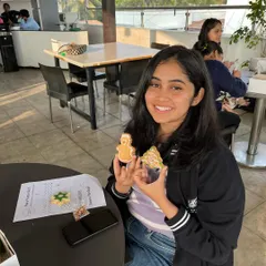 Look at that proud smile! She's showing off her beautifully decorated gingerbread man and Christmas tree cookies. It’s so rewarding to see people enjoying this creative break from work.