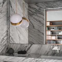 A bathroom clad entirely in Statuario marble, showcasing the material's dramatic veining and our ability to create monolithic forms.