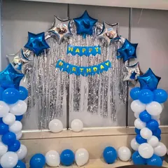A simple and effective birthday decoration for a small space. We used two balloon pillars and a star-shaped foil balloon arch to frame a silver shimmer curtain, creating an instant party corner.