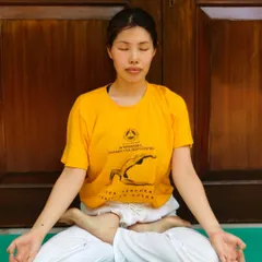A student sits in Padmasana (Lotus Pose) for meditation, embodying stillness and focus. Our workshops help you find a comfortable seated posture to support your practice.