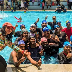 It's not just for kids. This happy group of adult swimmers celebrates the start of a fun-filled summer camp session, proving that learning and fun have no age limit.