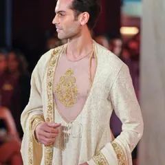 Male grooming for the Abu Jani Sandeep Khosla show. This look is clean and refined, focusing on flawless skin and subtly defined features to complement the regal, embroidered outfit.