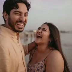 A close-up filled with infectious laughter. This candid shot captures the pure joy and fun of a day spent by the sea, reflecting a genuine and happy connection.