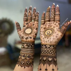 A personalized bridal design featuring the initials 'RS' and elephant motifs. The empty circle on the other hand is often used to write the groom's name.