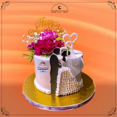 A modern and romantic anniversary cake. The silhouette of a couple, combined with fresh flowers and delicate heart toppers, creates a beautiful and personal way to celebrate another year of love.