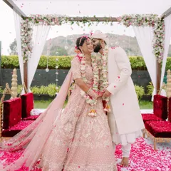 Pure elation under a shower of petals. This is the peak of the celebration, a vibrant, joyous moment from a beautiful North Indian wedding ceremony that we captured in all its colorful glory.