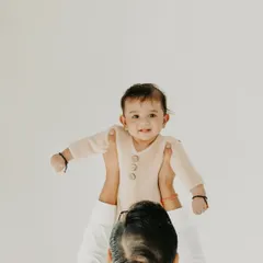 The world looks different from up here. I love capturing the dynamic and playful moments between a parent and child. This image of a father lifting his baby high is full of happiness and trust, a perfect memory from a family portrait session in my Noida studio.