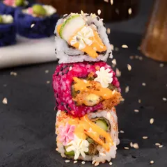 Who says vegetarian food can't be a work of art? I love creating dishes that are as beautiful as they are delicious. This stack of my signature sushi rolls shows the variety and creativity I bring to the table, using natural ingredients to create stunning colours and flavours.