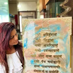 A student proudly holding the Navkar Maha Mantra frame she created in my workshop. It's a unique, handmade piece that she can now display in her home.