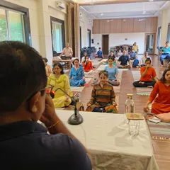 An instructor guides participants through a breathing technique. Our workshops are led by experts who provide clear, scientific explanations for each practice, ensuring a safe and profound learning experience.