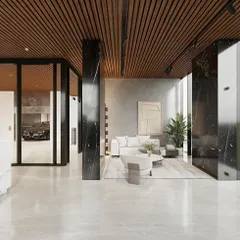 Here, the lobby seamlessly connects to its surroundings, with large glass panels offering a view of the outdoors and even the parking area. The design uses bold black marble pillars and a wood-slatted ceiling to tell a story of modern luxury and transparency.