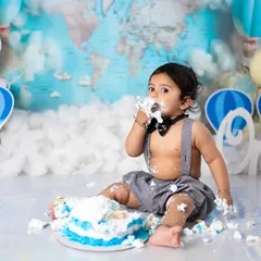 A close-up on the action. We focus on your baby's delighted expression as they explore the texture and taste of their cake.