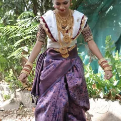 This is a traditional Kokani bridal look, which features a distinct style of saree draping and ornamentation. My courses cover the nuances of different regional bridal styles to make you a versatile makeup artist.
