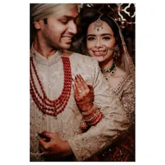 The warmth of an embrace. This candid shot captures the bride's joyful smile as she hugs her groom from behind, a moment of pure happiness and affection.