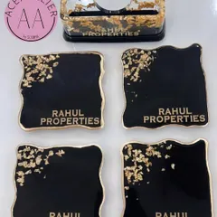 Here is an example of a sophisticated corporate gift set I created. This black and gold theme includes four personalized coasters and a matching cardholder, all featuring the company's name, "Rahul Properties," for a professional and lasting impression.