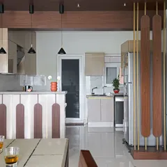 After: The kitchen was reconfigured into an open U-shape with a breakfast bar, modern cabinets, and improved functionality, completely changing the flow of the space.