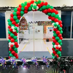 A grand red, green, and white balloon arch designed for a corporate office entrance during the Christmas season. This festive decoration welcomes employees and visitors, complete with sparkling tinsel at the base for an extra touch of holiday cheer.