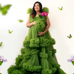 A touch of whimsy with floating butterflies adds to the enchanting feel of this portrait in a stunning green gown.
