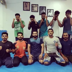 A group shot after a tough training session. We offer kids and adults MMA and BJJ classes, with free trial classes available for newcomers.