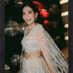 The bride, Anjali, glowing amidst the disco balls. This shot captures her joy and the vibrant atmosphere of the Sangeet night, using the party lights to create a dynamic and celebratory portrait.