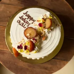 A birthday cake for 'Aai' (mom) in one of my most-loved Indian fusion flavors: Gulabjamun Rabdi. I top it with actual gulab jamuns, chopped nuts, and edible flower petals for a truly special treat.