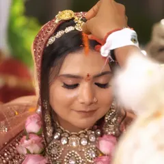 A close-up during the sindoor ceremony, highlighting the makeup's precision and durability. Even in intimate, emotional moments, the look remains impeccable, with defined lashes and a smooth skin finish.