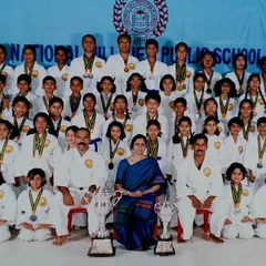 A proud moment with the talented karate team of National Hill View Public School. This group photo was taken after a successful tournament, showcasing their medals and championship trophies.