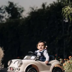 A stylish little driver in her vintage convertible. I love using these ride-on car props to create fun, imaginative portraits for toddlers.