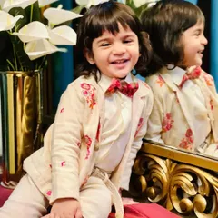 The joy on a child's face is the best reward. This picture captures the playful spirit of my kids' couture line, showing the fine embroidery detail on the jacket.
