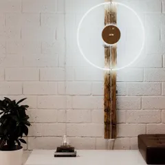 More than a clock, our STORY timepiece is a piece of kinetic art. This setup shows its potential as a large, wall-mounted installation, with the levitating sphere orbiting a wooden disc, creating a stunning visual focal point in any room.