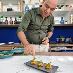 Every dish we create is a piece of our passion. Here, I'm adding the final touches to our open quesadillas, ensuring each appetizer is a perfect blend of flavor, texture, and artistry before it reaches your guests.