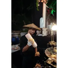 A member of my team dressed in theme-appropriate attire for a Pan-Asian station, showcasing how we adapt our presentation to fit the event's concept.