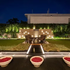 This garden comes alive at night with a beautifully lit water feature and an illuminated accent wall. The strategic use of warm, indirect lighting creates a sophisticated and inviting ambiance for evening entertaining or quiet contemplation.