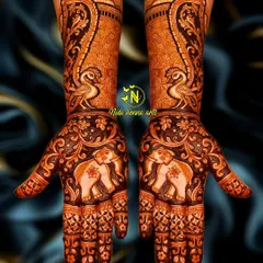 A designer mehandi with an animal theme, featuring bold elephants on the palms and elegant peacocks on the arms. This creates a symmetrical and striking look.